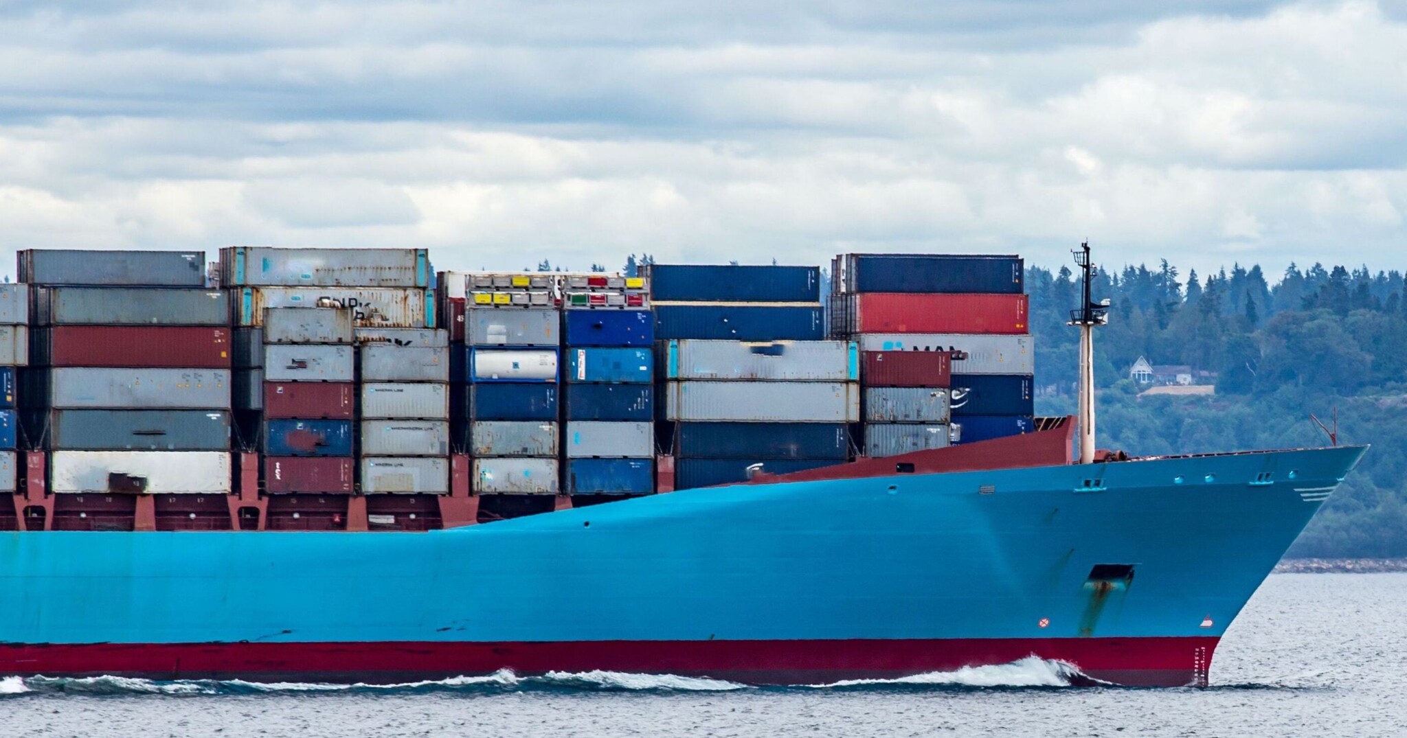 A photograph of a large blue container ship.